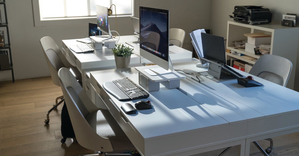 Office setup with several monitors using Kensington CoolView™ Wellness Monitor Stands