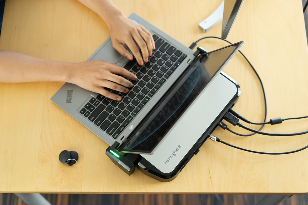 A laptop using a LD5400T Thunderbolt 3 Universal Dual 4K Dock with K-Fob Smart Lock 