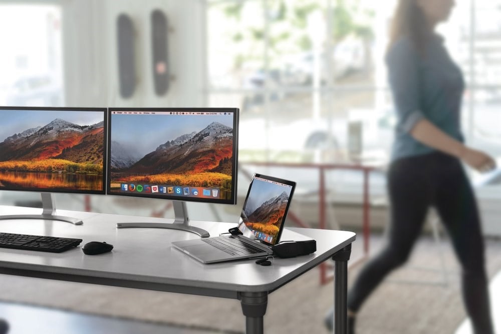 A MacBook setup at desk and connected to a Kensington locking station