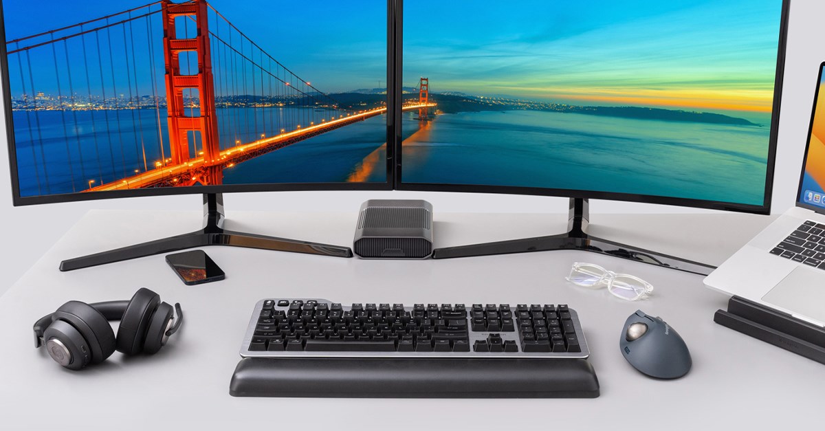 New Kensington Silent Mechanical Keyboard on a desk set up with dual monitors and a H3000 headset.