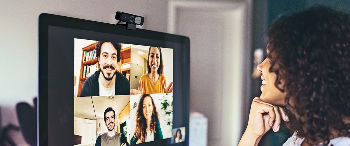 Woman shown on virtual meeting on laptop with a Webcam.