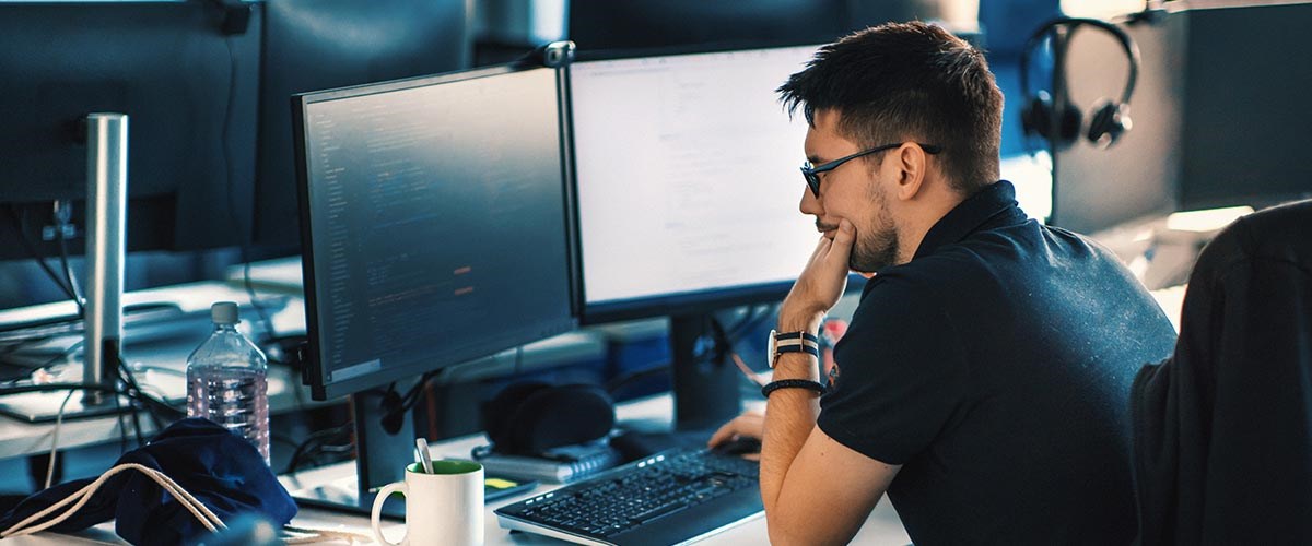  A man is working and analyzing data on his computer.