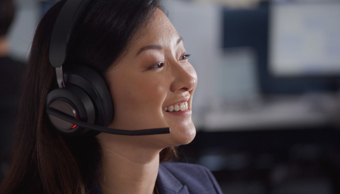 Woman putting on a Kensington headset.