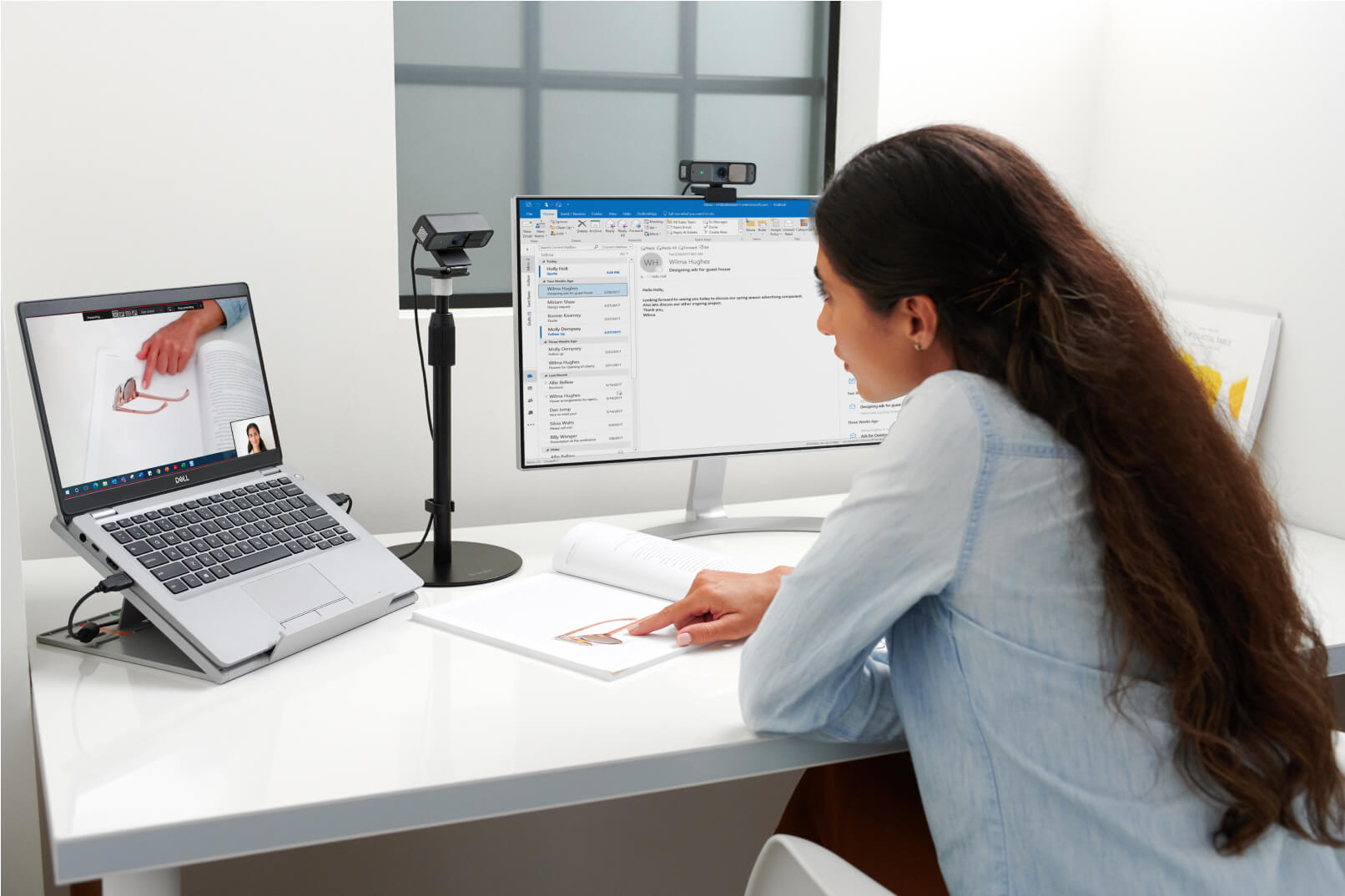 woman working at desk with Kensington webcam