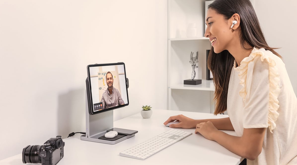 Woman on a virtual call with an iPad connected to a Kensington StudioDock