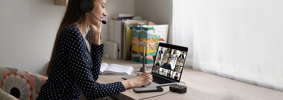 Person using Kensington audio switch during virtual meeting