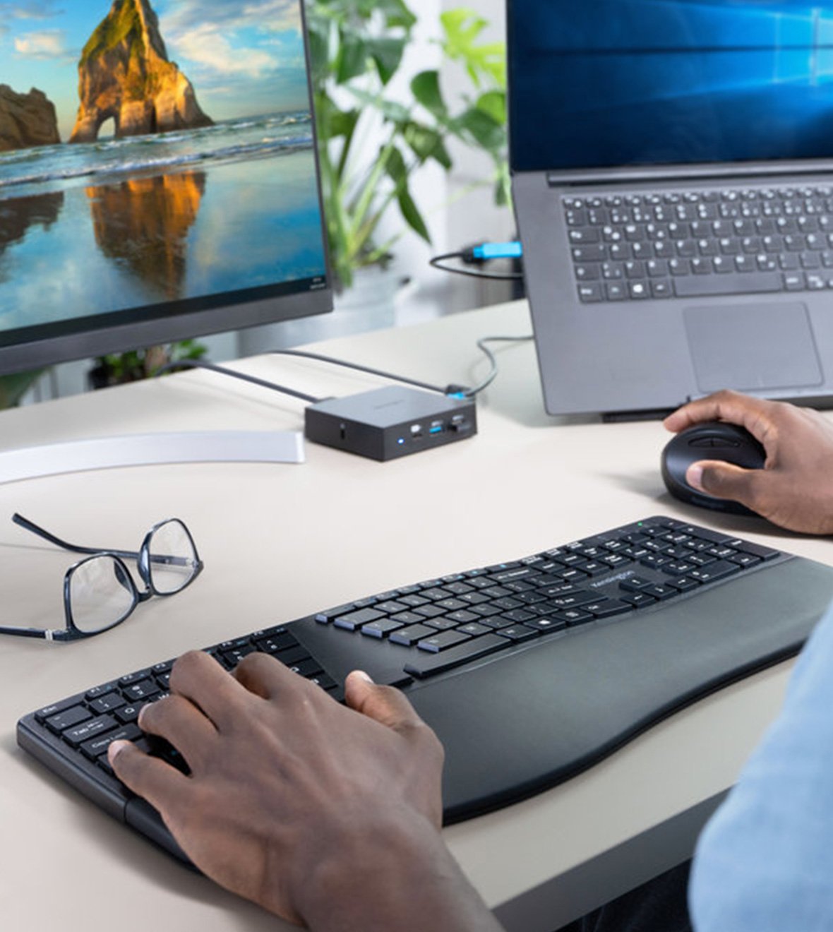 Closeup of person using Kensington keyboard and trackball