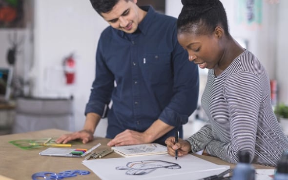 Two people looking at a design on paper