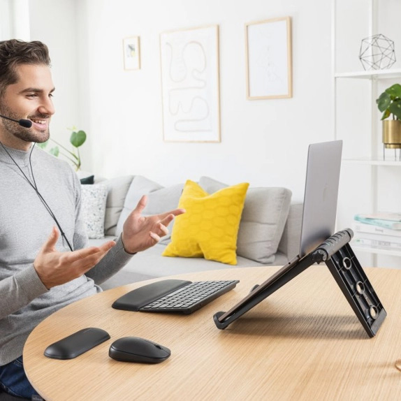 Man using Kensington laptop riser at home