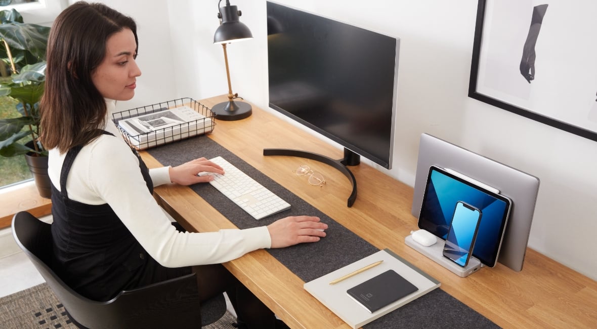 Woman working at a desk with a Kensington StudioCaddy